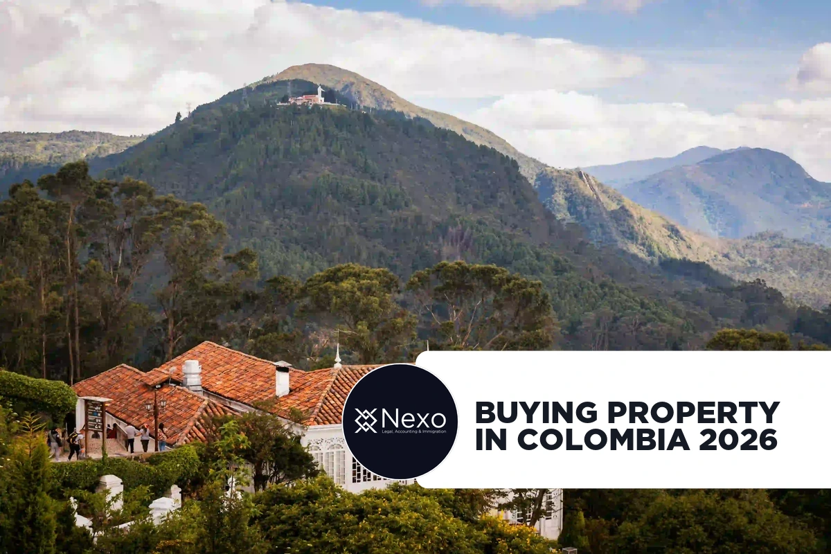 buying property in Colombia 2026 — foreigner reviewing property documents with Colombian notary