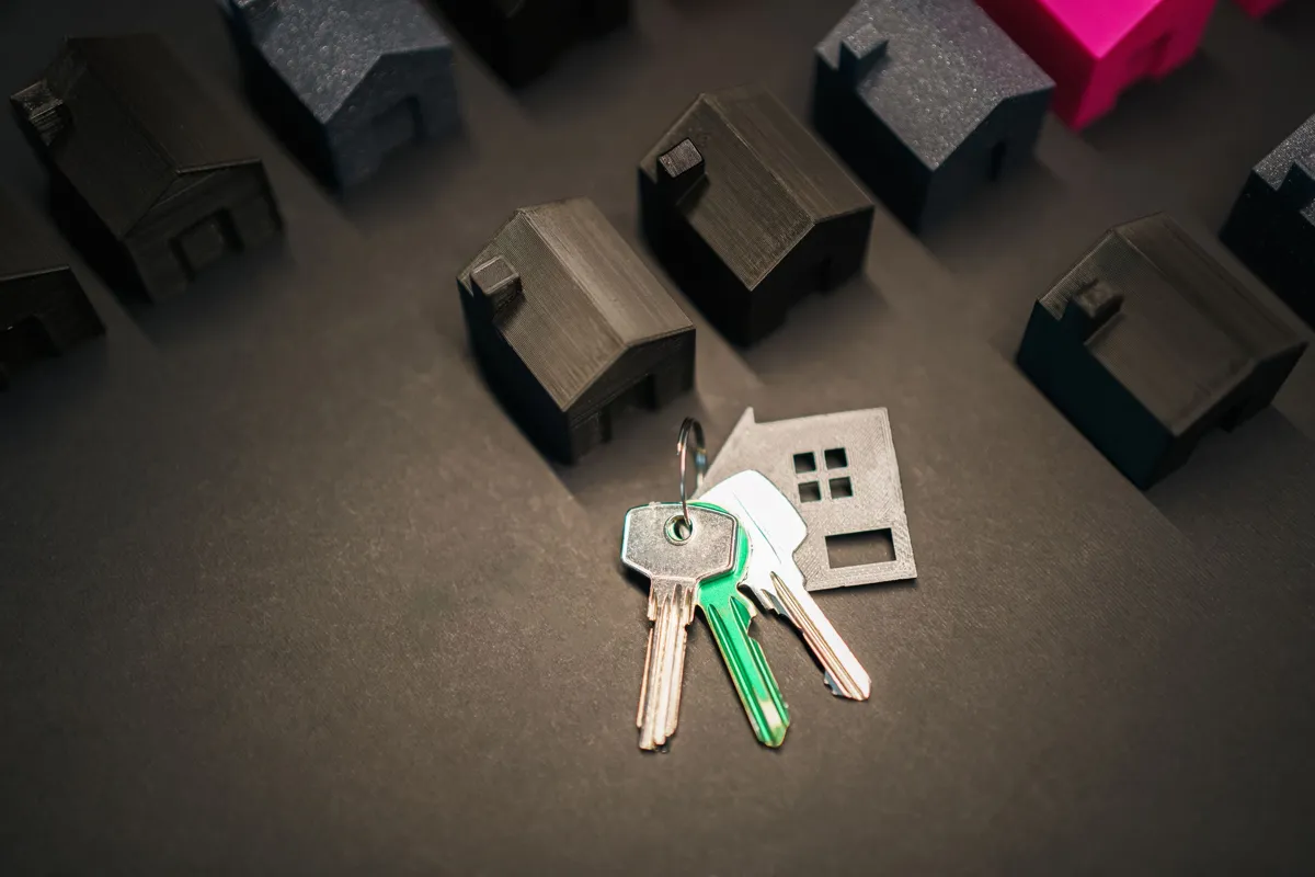 Increase in Property Tax Assessment in Colombia for 2026: Everything You Need to Know model houses and keys representing rural and urban properties in Colombia